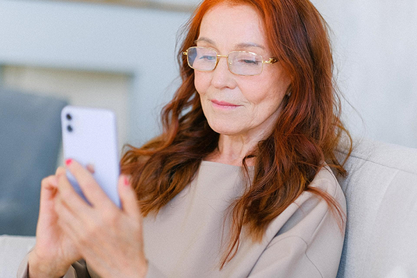 Older Lady Looking At A Cell Phone